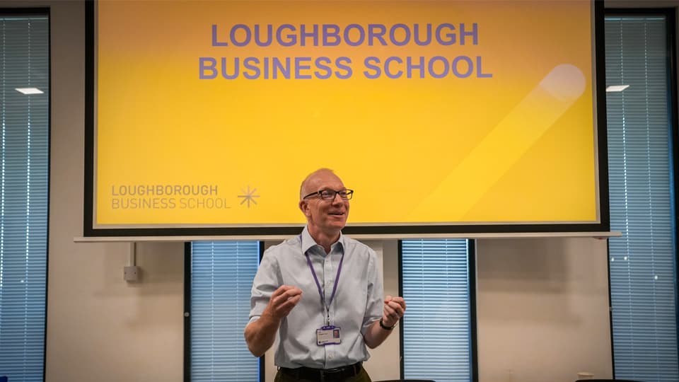 Professor Crispin Coombs presenting to a lecture theatre.